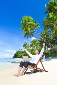 Happy Businessman Working on a Tropical Beach